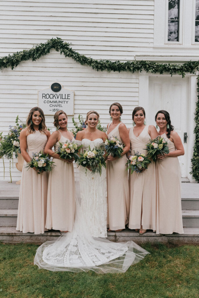Bride with a group of her bridesmaids holding bouquets
